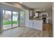 Open kitchen with backyard access, white cabinets, and stainless steel appliances at 6420 Greenspire Pl, Indianapolis, IN 46221