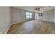 Spacious living room boasts hardwood floors, a ceiling fan, and seamlessly flows into the adjacent kitchen at 6420 Greenspire Pl, Indianapolis, IN 46221