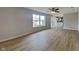 Bright living room with hardwood flooring leading to a bright open-plan kitchen and backyard access at 6420 Greenspire Pl, Indianapolis, IN 46221