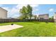 Expansive backyard featuring a well-maintained lawn, bordered by a wood fence with a concrete patio and a small sandbox at 6837 W Burlington Dr, McCordsville, IN 46055