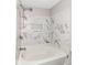 Bathroom featuring a bathtub with a shower head and decorative wall tile at 6837 W Burlington Dr, McCordsville, IN 46055