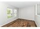 Bright, empty bedroom featuring new wood flooring and natural light from the double windows at 6837 W Burlington Dr, McCordsville, IN 46055