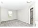 This bedroom features neutral walls, plush gray carpeting, and a bright window at 6837 W Burlington Dr, McCordsville, IN 46055