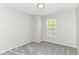 Neutral bedroom with plush carpet, light gray walls, and a window with natural light at 6837 W Burlington Dr, McCordsville, IN 46055