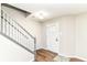 Inviting entryway with new wood flooring, a staircase, and a white front door at 6837 W Burlington Dr, McCordsville, IN 46055