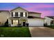 Charming two-story home with a well-manicured lawn, a two-car garage, and classic blue shutters at 6837 W Burlington Dr, McCordsville, IN 46055
