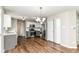 Modern kitchen featuring stainless steel appliances, stylish lighting, and luxury vinyl flooring at 6837 W Burlington Dr, McCordsville, IN 46055