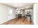 Eat-in kitchen with stainless appliances, modern lighting, and beautiful luxury vinyl floors at 6837 W Burlington Dr, McCordsville, IN 46055
