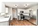 Bright eat-in kitchen with stainless steel appliances and luxury vinyl floors at 6837 W Burlington Dr, McCordsville, IN 46055