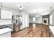 Updated eat-in kitchen area with stainless steel appliances and luxury vinyl flooring at 6837 W Burlington Dr, McCordsville, IN 46055