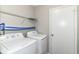 Convenient laundry room with washer, dryer, and shelving for extra storage space at 6837 W Burlington Dr, McCordsville, IN 46055