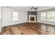 Spacious living room features luxury vinyl flooring and fireplace with stone surround at 6837 W Burlington Dr, McCordsville, IN 46055