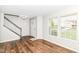 Bright living room features wood flooring, natural light, and staircase at 6837 W Burlington Dr, McCordsville, IN 46055