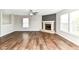 Open concept living room with luxury vinyl floors, fireplace, and abundant natural light at 6837 W Burlington Dr, McCordsville, IN 46055