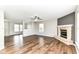 Bright living room featuring gorgeous luxury vinyl floors and fireplace at 6837 W Burlington Dr, McCordsville, IN 46055