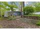 Secluded backyard with mature trees, landscaping, and a cozy screened porch for relaxation at 7 Lake Hart, Mooresville, IN 46158