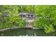 Exterior view of home with dock and lake access surrounded by lush trees at 7 Lake Hart, Mooresville, IN 46158