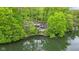 Exterior view of lakefront property showcasing lush greenery and lake access at 7 Lake Hart, Mooresville, IN 46158