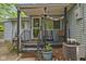 Inviting front porch with chairs and decor, accessible by a small set of stairs with railings and plants at 7 Lake Hart, Mooresville, IN 46158