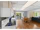 Well-lit kitchen features white appliances and a table with chairs near a window and an exit to a patio at 7 Lake Hart, Mooresville, IN 46158