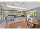 Well-lit kitchen features white appliances, a wood table with chairs, and an exit to an outdoor patio at 7 Lake Hart, Mooresville, IN 46158