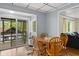 A table with four chairs is near a sliding glass door in this kitchen with a view to the outside at 7 Lake Hart, Mooresville, IN 46158