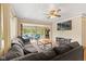 Inviting living room with lake views, a large sofa, wood floors and a ceiling fan at 7 Lake Hart, Mooresville, IN 46158
