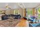 Comfortable living room features wood floors, a large sofa and water views at 7 Lake Hart, Mooresville, IN 46158