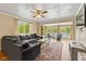 Bright and comfortable living room with large windows offering scenic views, a cozy couch, and natural lighting at 7 Lake Hart, Mooresville, IN 46158