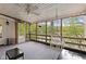 Relaxing screened-in patio featuring string lights, comfortable seating, and a ceiling fan at 7 Lake Hart, Mooresville, IN 46158