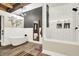 Beautiful bathroom with a freestanding tub, walk-in shower, and modern fixtures, all under an exposed beam ceiling at 735 Lexington Ave # Apt 27, Indianapolis, IN 46203