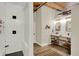 Bright bathroom with a walk-in shower, double sinks, white subway tiles and exposed beam ceiling at 735 Lexington Ave # Apt 27, Indianapolis, IN 46203