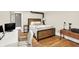 Cozy bedroom with hardwood floors, a modern desk, and a rustic bedframe at 735 Lexington Ave # Apt 27, Indianapolis, IN 46203