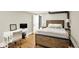 Comfortable bedroom featuring a rustic bedframe, hardwood floors, and a desk area at 735 Lexington Ave # Apt 27, Indianapolis, IN 46203