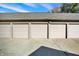 Three-car garage with neutral doors and a gray roof, providing ample parking and storage at 735 Lexington Ave # Apt 27, Indianapolis, IN 46203