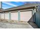 Three-car garage with light doors, blue dividers, and a gray roof at 735 Lexington Ave # Apt 27, Indianapolis, IN 46203
