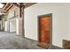Hallway featuring exposed brick, high ceilings, and a unit entrance with a welcome mat at 735 Lexington Ave # Apt 27, Indianapolis, IN 46203