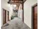 Hallway featuring exposed brick, a skylight, and multiple apartment entrances for a unique living experience at 735 Lexington Ave # Apt 27, Indianapolis, IN 46203