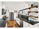 Bright kitchen features white cabinets, stainless steel appliances, and a bar area with open shelving at 735 Lexington Ave # Apt 27, Indianapolis, IN 46203
