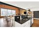Open kitchen with breakfast bar overlooking the living area with exposed brick and a fireplace at 735 Lexington Ave # Apt 27, Indianapolis, IN 46203