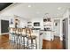 Modern kitchen with white cabinets, black countertops, stainless steel appliances, and breakfast bar at 735 Lexington Ave # Apt 27, Indianapolis, IN 46203
