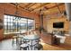 Bright living room with exposed brick, wooden ceilings, and city views at 735 Lexington Ave # Apt 27, Indianapolis, IN 46203