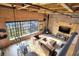 Open-concept living room with high ceilings, exposed brick, large windows, and modern furniture at 735 Lexington Ave # Apt 27, Indianapolis, IN 46203