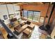 Open-concept living room featuring exposed brick, large windows, a plush sectional, and a cozy fireplace at 735 Lexington Ave # Apt 27, Indianapolis, IN 46203