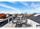 Outdoor rooftop patio features city views and a metal table and chairs for relaxing and entertaining at 735 Lexington Ave # Apt 27, Indianapolis, IN 46203