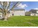 Spacious backyard featuring a well-maintained lawn, mature tree, and two-story house in a suburban setting at 7907 Oakdale Ln, Indianapolis, IN 46214