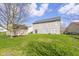 Backyard view featuring a home, storage shed, green lawn, providing a spacious outdoor retreat at 7907 Oakdale Ln, Indianapolis, IN 46214