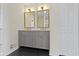 Bathroom with a dual sink vanity, black hexagon tiled floor, and modern fixtures and features at 7907 Oakdale Ln, Indianapolis, IN 46214