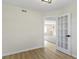 Bright bedroom with a view into another room, wood flooring, and white trim at 7907 Oakdale Ln, Indianapolis, IN 46214