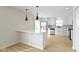 Modern kitchen featuring white cabinets, stainless steel appliances, and a breakfast bar at 7907 Oakdale Ln, Indianapolis, IN 46214